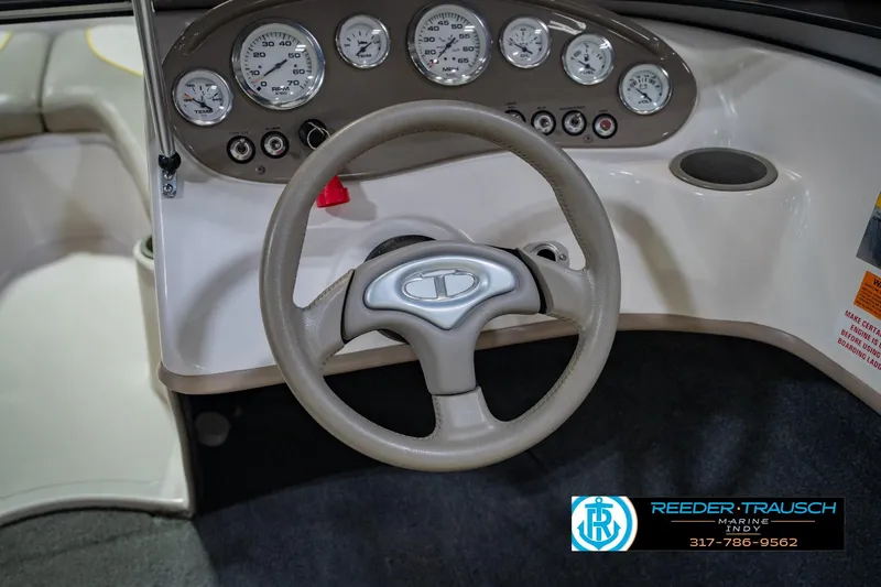 Slide: The Image of 2005 Tahoe Q4 boat dashboard with steering wheel and gauges, Reeder-Trausch Marine logo visible. - 25