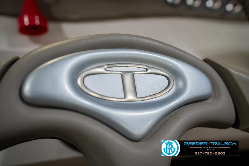 Slide: The Image of Steering wheel of a 2005 Tahoe Q4 boat with logo and Reeder-Trausch Marine branding. - 26