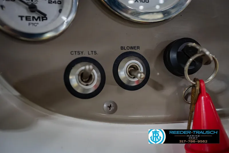 Slide: The Image of Dashboard controls of a 2005 Tahoe Q4 boat with ignition keys and switches. - 27