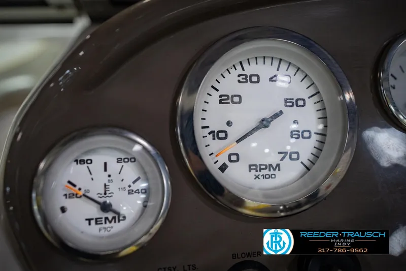 Slide: The Image of Dashboard gauges of a 2005 Tahoe Q4 boat, showing RPM and temperature readings. - 28