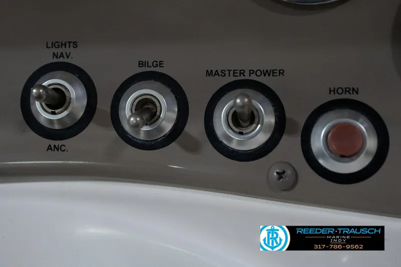 Slide: The Image of Control panel of a 2005 Tahoe Q4 boat with switches for lights, bilge, power, and horn. - 31