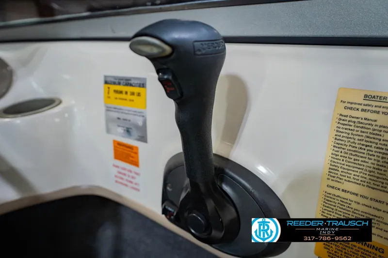 Slide: The Image of Close-up of a 2005 Tahoe Q4 boat throttle control with safety instructions. - 33