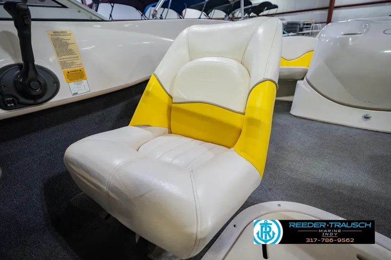 Slide: The Image of 2005 Tahoe Q4 boat seat with yellow and white upholstery in showroom setting. - 34