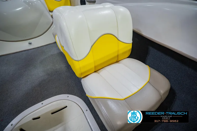 Slide: The Image of 2005 Tahoe Q4 boat seat with yellow and beige upholstery, featuring Reeder-Trausch Marine logo. - 35