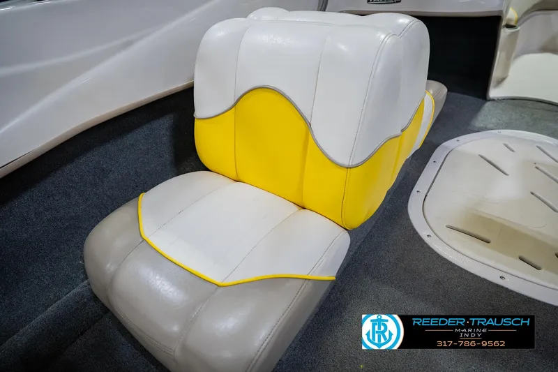 Slide: The Image of 2005 Tahoe Q4 boat interior with yellow and white seating, Reeder Trausch Marine logo visible. - 36