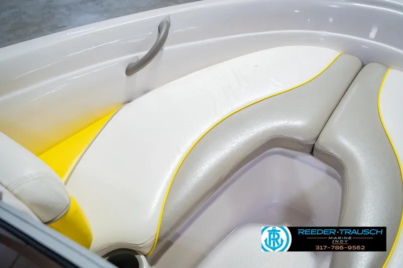 Slide: The Image of 2005 Tahoe Q4 boat interior with white and yellow cushioned seating. - 38