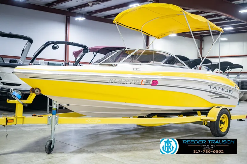 Slide: The Image of Yellow 2005 Tahoe Q4 boat with canopy on trailer in showroom. - 4