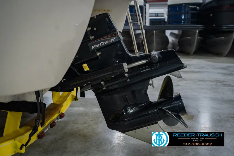 Slide: The Image of 2005 Tahoe Q4 boat with MerCruiser engine, displayed indoors on a yellow trailer. - 42