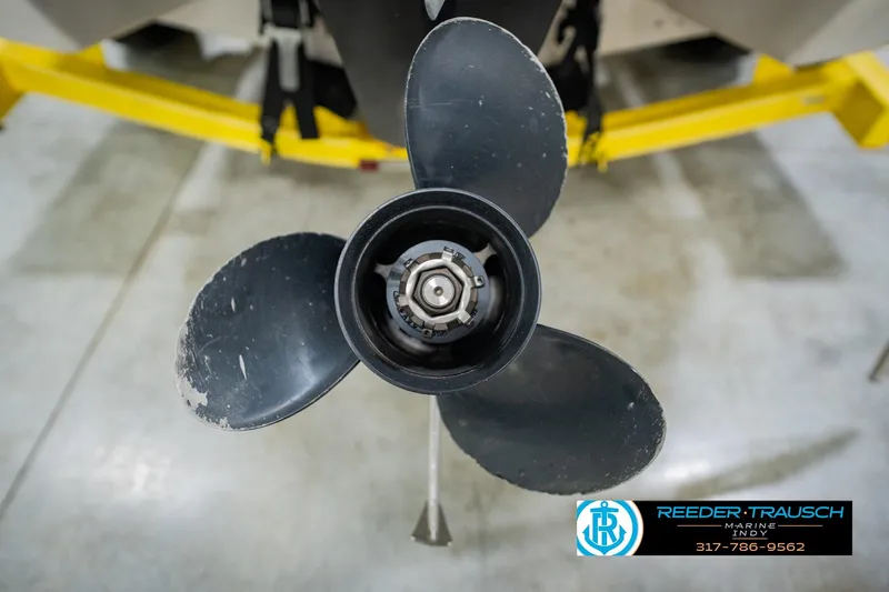 Slide: The Image of Close-up of a 2005 Tahoe Q4 boat propeller in a workshop setting. - 45