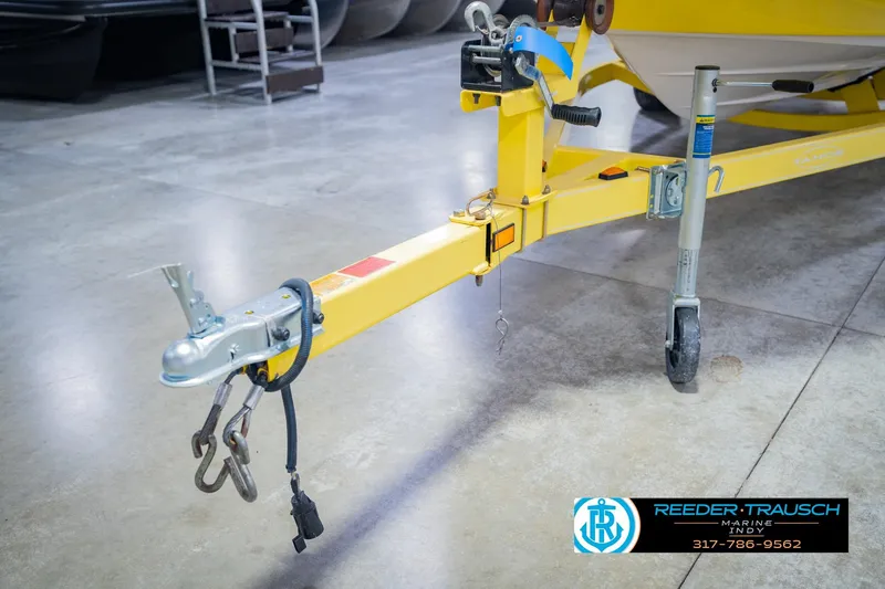 Slide: The Image of Yellow trailer hitch of a 2005 Tahoe Q4 boat in a showroom. - 48