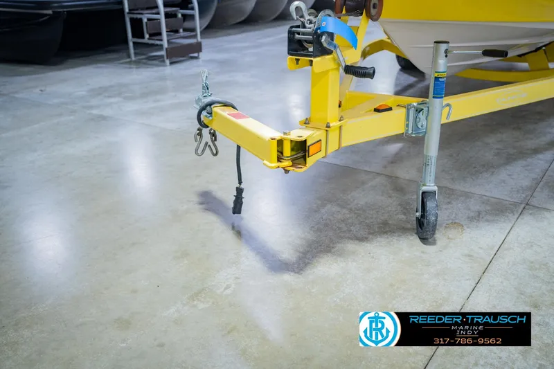 Slide: The Image of Yellow trailer hitch of a 2005 Tahoe Q4 boat on a polished concrete floor. - 49