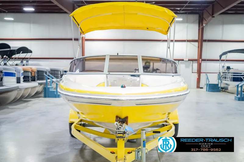 Slide: The Image of Yellow 2005 Tahoe Q4 boat with canopy in indoor showroom. - 5