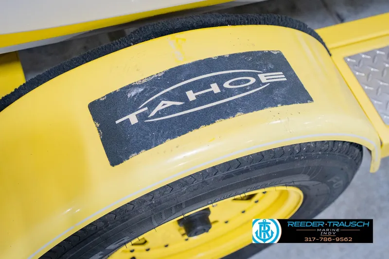 Slide: The Image of Yellow 2005 Tahoe Q4 trailer fender with logo and Reeder-Trausch Marine contact details. - 51