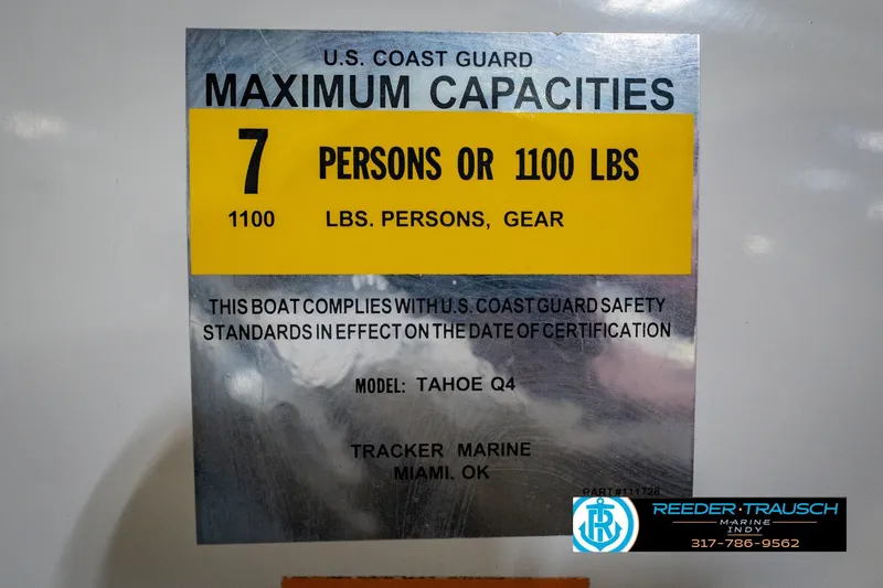 Slide: The Image of 2005 Tahoe Q4 boat capacity label, 7 persons or 1100 lbs, U.S. Coast Guard compliant. - 55