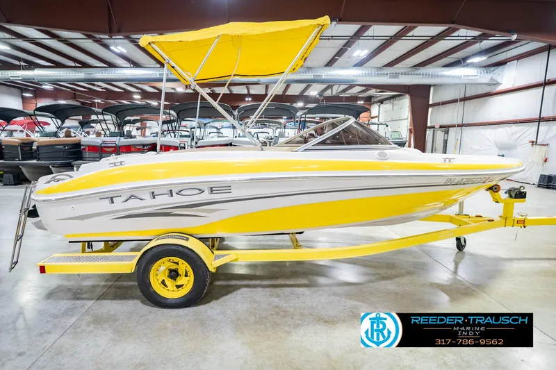 Slide: The Image of Yellow 2005 Tahoe Q4 boat with canopy on trailer in indoor showroom. - 7