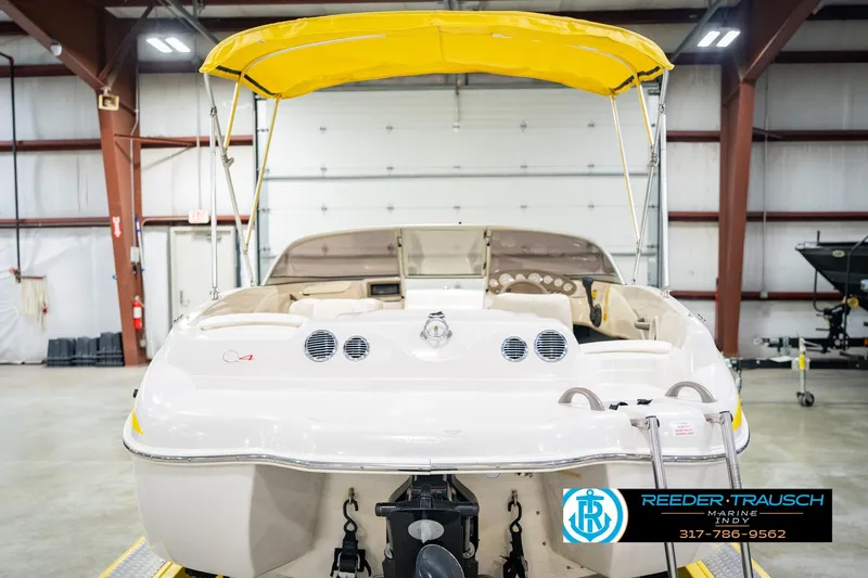 Slide: The Image of 2005 Tahoe Q4 boat with yellow canopy in indoor storage facility. - 9