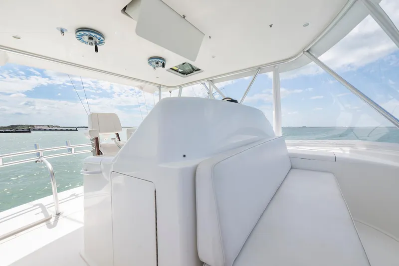 Slide: The Image of 2009 Viking 50 Convertible yacht interior with white seating and ocean view. - 11