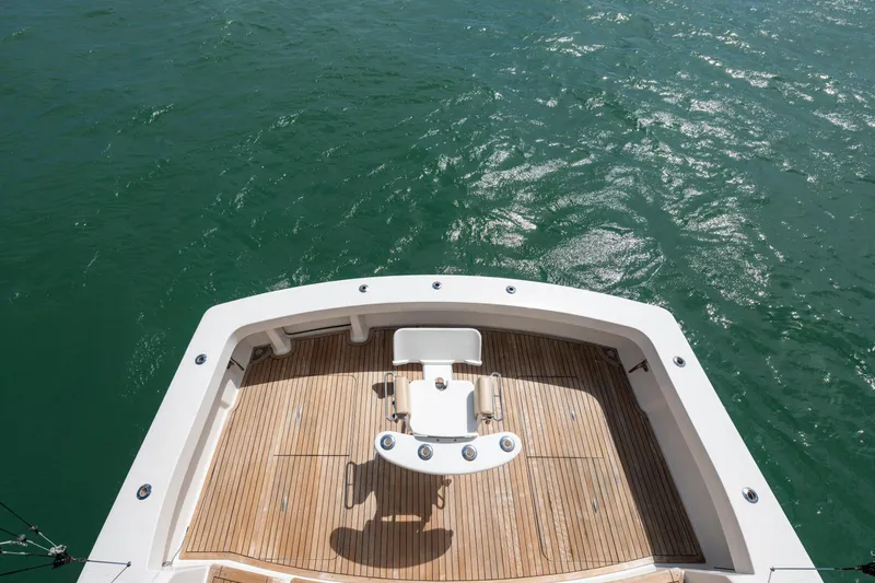 Slide: The Image of 2009 Viking 50 Convertible yacht deck overlooking calm green waters. - 12