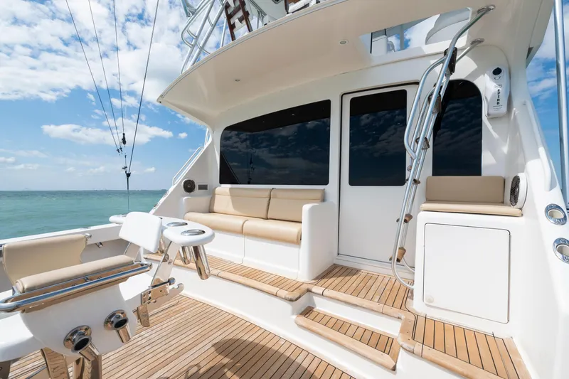Slide: The Image of 2009 Viking 50 Convertible yacht deck with seating, ocean view, and clear sky. - 13