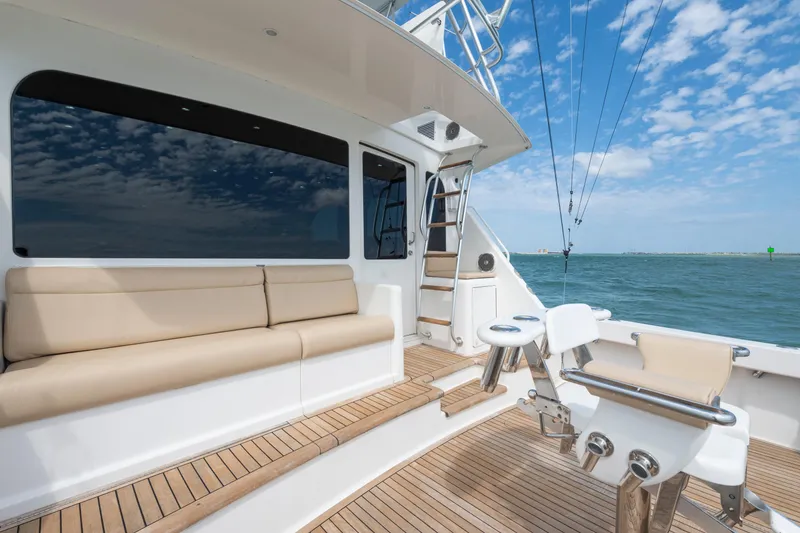 Slide: The Image of 2009 Viking 50 Convertible yacht deck with seating, ocean view, and clear blue sky. - 15