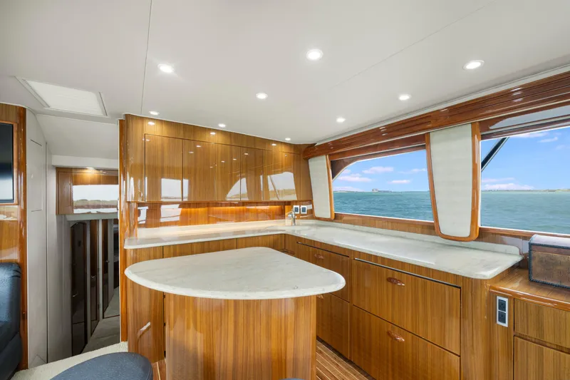 Slide: The Image of Luxurious interior of 2009 Viking 50 Convertible yacht with wooden cabinetry and ocean view. - 18