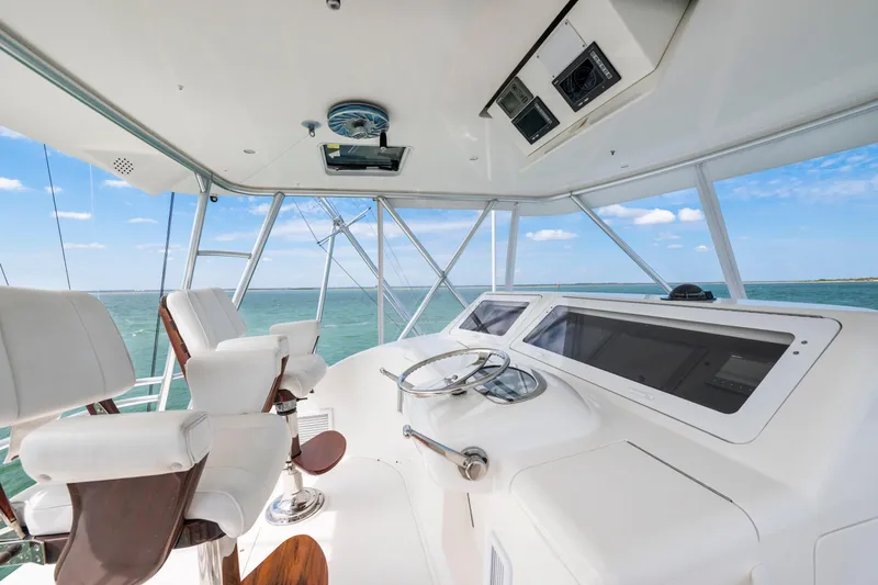 Slide: The Image of 2009 Viking 50 Convertible yacht helm with ocean view and modern controls. - 3