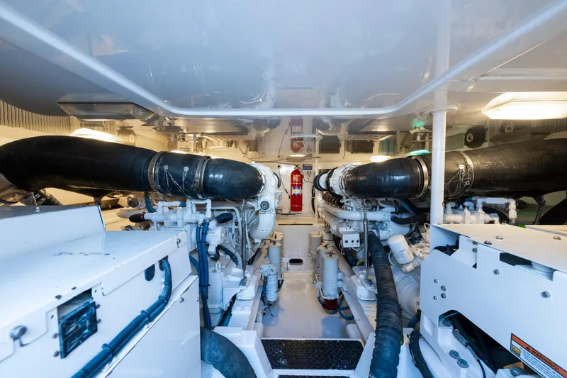Slide: The Image of Engine room of 2009 Viking 50 Convertible yacht, featuring dual engines and fire extinguisher. - 30