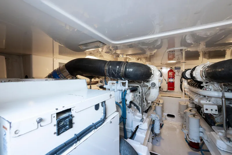 Slide: The Image of Engine room of 2009 Viking 50 Convertible yacht, featuring dual engines and fire extinguisher. - 32