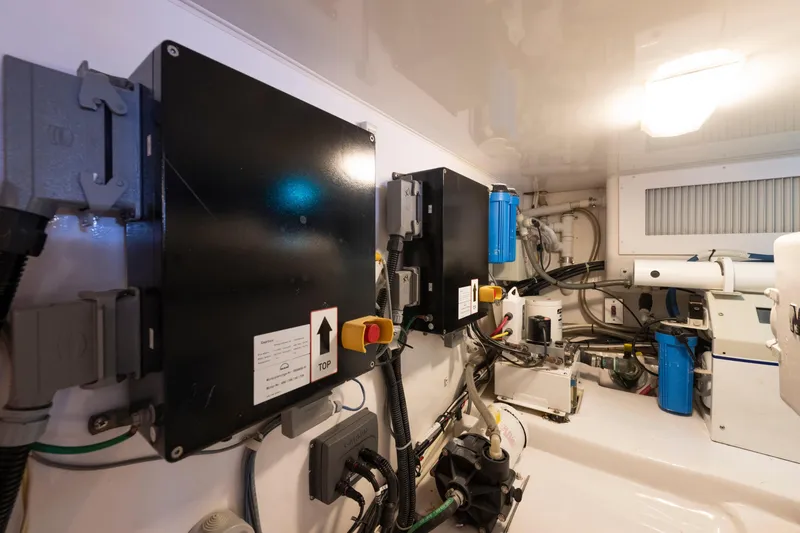 Slide: The Image of Engine room of 2009 Viking 50 Convertible yacht, showcasing electrical panels and machinery. - 36