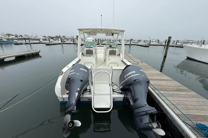 Slide: The Image of 2018 World Cat 295 DC boat docked with twin Yamaha outboard engines. - 3