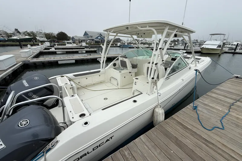 Slide: The Image of 2018 World Cat 295 DC boat docked at marina with twin Yamaha engines. - 4