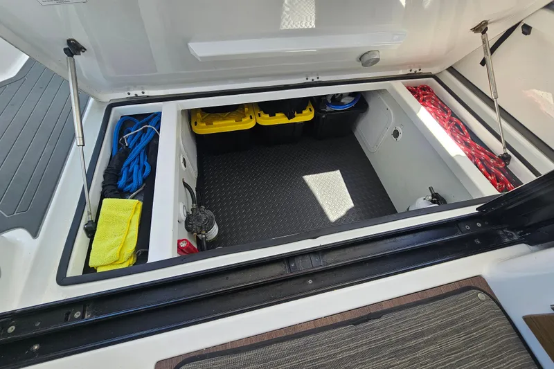 Slide: The Image of Storage compartment of 2021 Jeanneau NC Weekender 895 with ropes and equipment. - 18