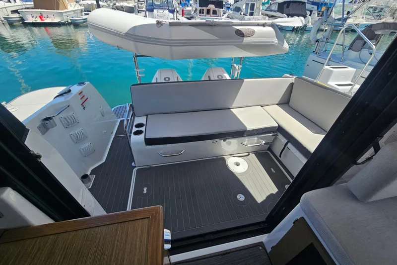Slide: The Image of 2021 Jeanneau NC Weekender 895 boat interior with seating and water view. - 19