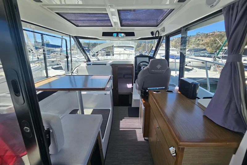 Slide: The Image of Interior of 2021 Jeanneau NC Weekender 895, featuring seating and helm station. - 20