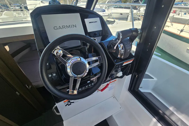 Slide: The Image of 2021 Jeanneau NC Weekender 895 helm with Garmin and Mercury controls. - 21