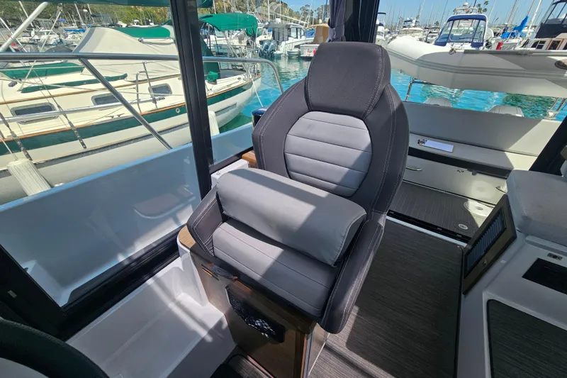 Slide: The Image of Captain's seat on 2021 Jeanneau NC Weekender 895, docked at marina. - 22