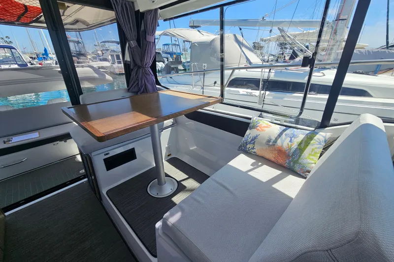 Slide: The Image of Interior of 2021 Jeanneau NC Weekender 895 with table and seating, docked at marina. - 24