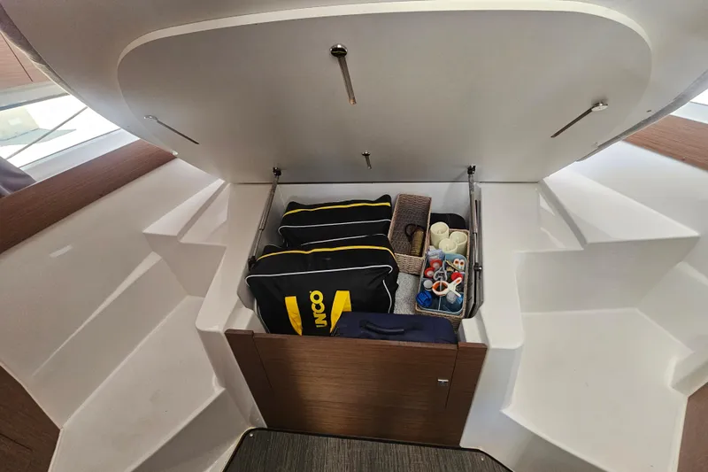 Slide: The Image of Storage compartment in 2021 Jeanneau NC Weekender 895, organized with bags and accessories. - 27