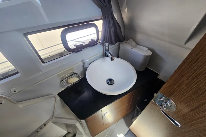 Slide: The Image of Bathroom interior of 2021 Jeanneau NC Weekender 895 with sink and window. - 29
