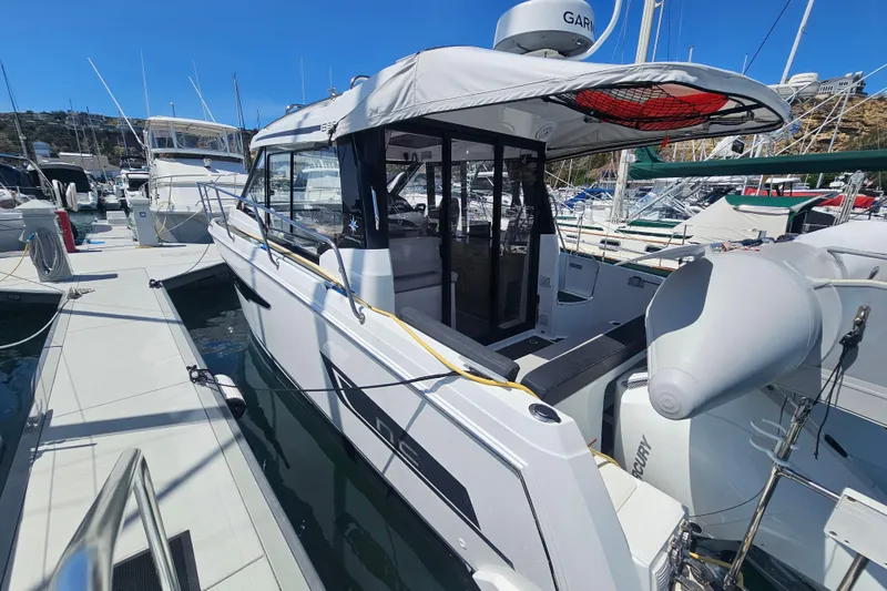 Slide: The Image of 2021 Jeanneau NC Weekender 895 docked at marina, showcasing sleek design and modern features. - 3