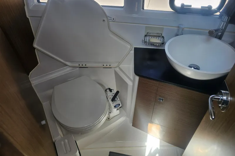 Slide: The Image of 2021 Jeanneau NC Weekender 895 bathroom with toilet and modern sink. - 30