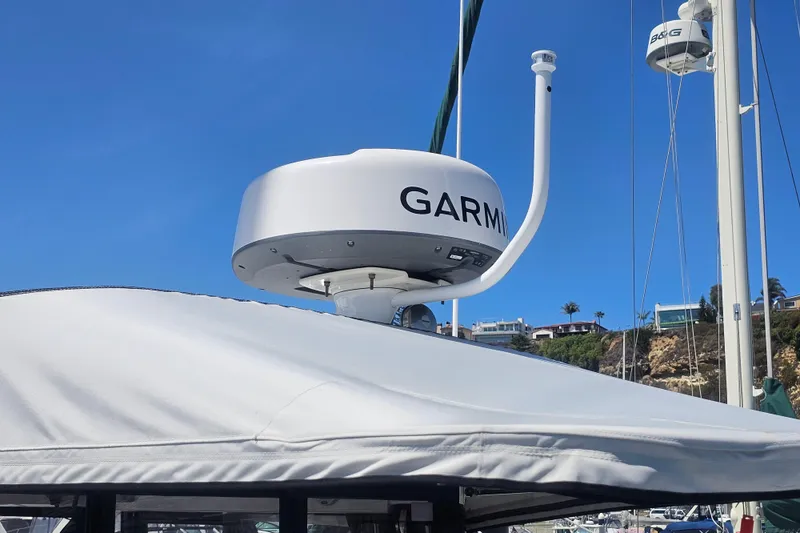 Slide: The Image of Garmin radar on 2021 Jeanneau NC Weekender 895 boat under clear blue sky. - 4