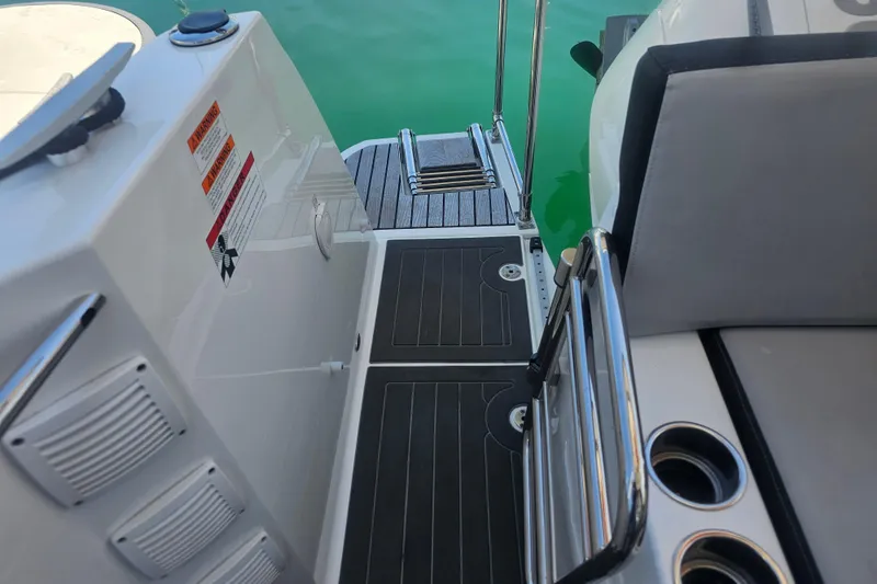 Slide: The Image of 2021 Jeanneau NC Weekender 895 boat deck with seating and cup holders. - 8