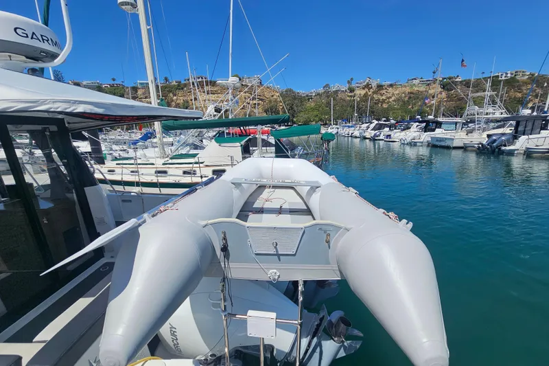 Slide: The Image of Jeanneau NC Weekender 895, 2021 model, docked with inflatable boat in marina. - 9