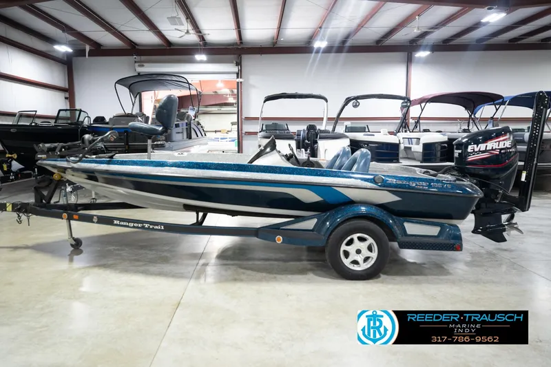 Slide: The Image of 2007 Ranger 188 VS boat in showroom, featuring Evinrude engine and trailer. - 13