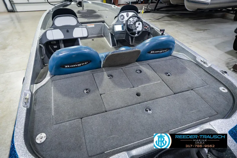 Slide: The Image of 2007 Ranger 188 VS boat interior with blue seats and steering console. - 17