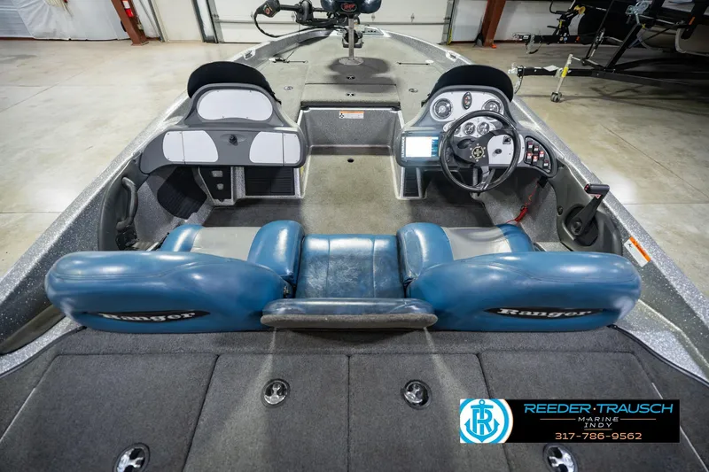 Slide: The Image of 2007 Ranger 188 VS boat interior with blue seats and steering console. - 18