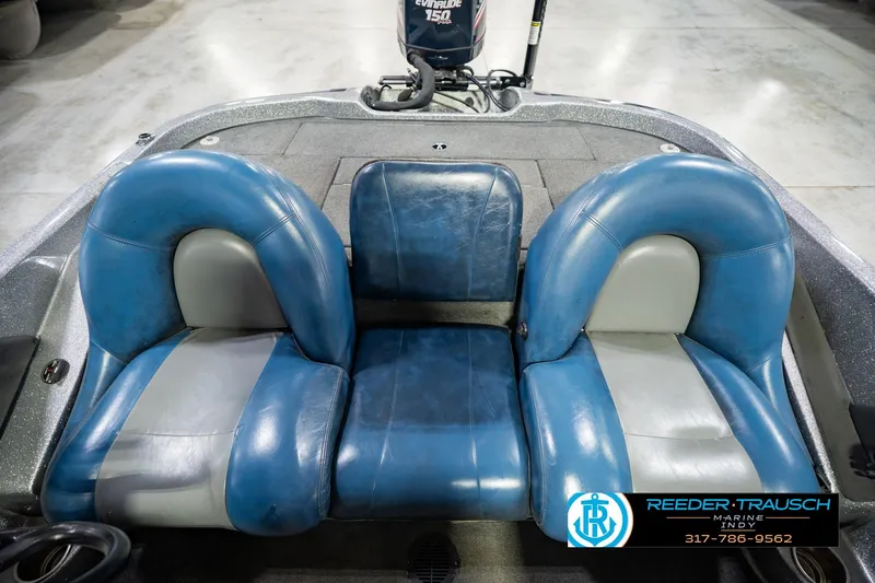 Slide: The Image of 2007 Ranger 188 VS boat interior with blue and gray seating, Evinrude motor visible. - 23