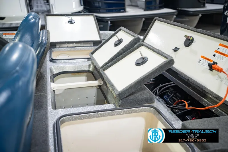 Slide: The Image of 2007 Ranger 188 VS boat storage compartments and seating, featuring open hatches and visible wiring. - 25