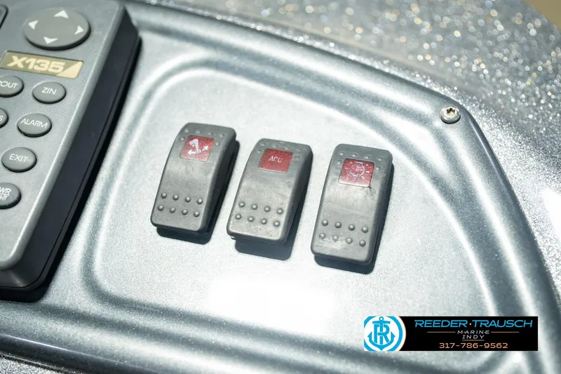 Slide: The Image of Control panel of a 2007 Ranger 188 VS boat with switches and keypad. - 49